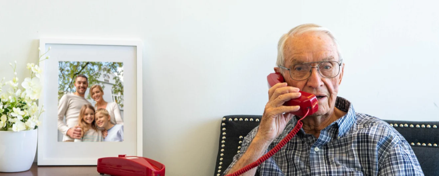 Man using corded phone